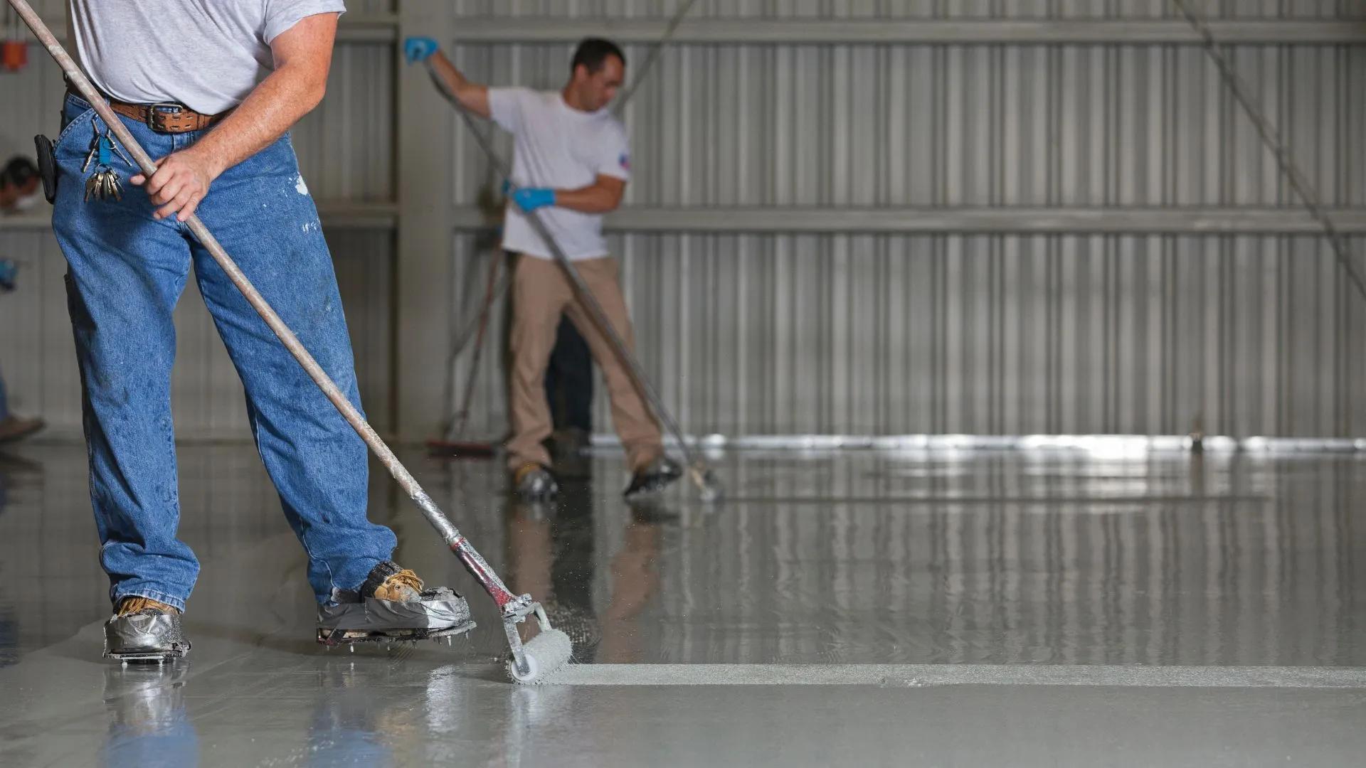 St George's BJ's Painting and Epoxy Floors laying down a big commercial epoxy floor