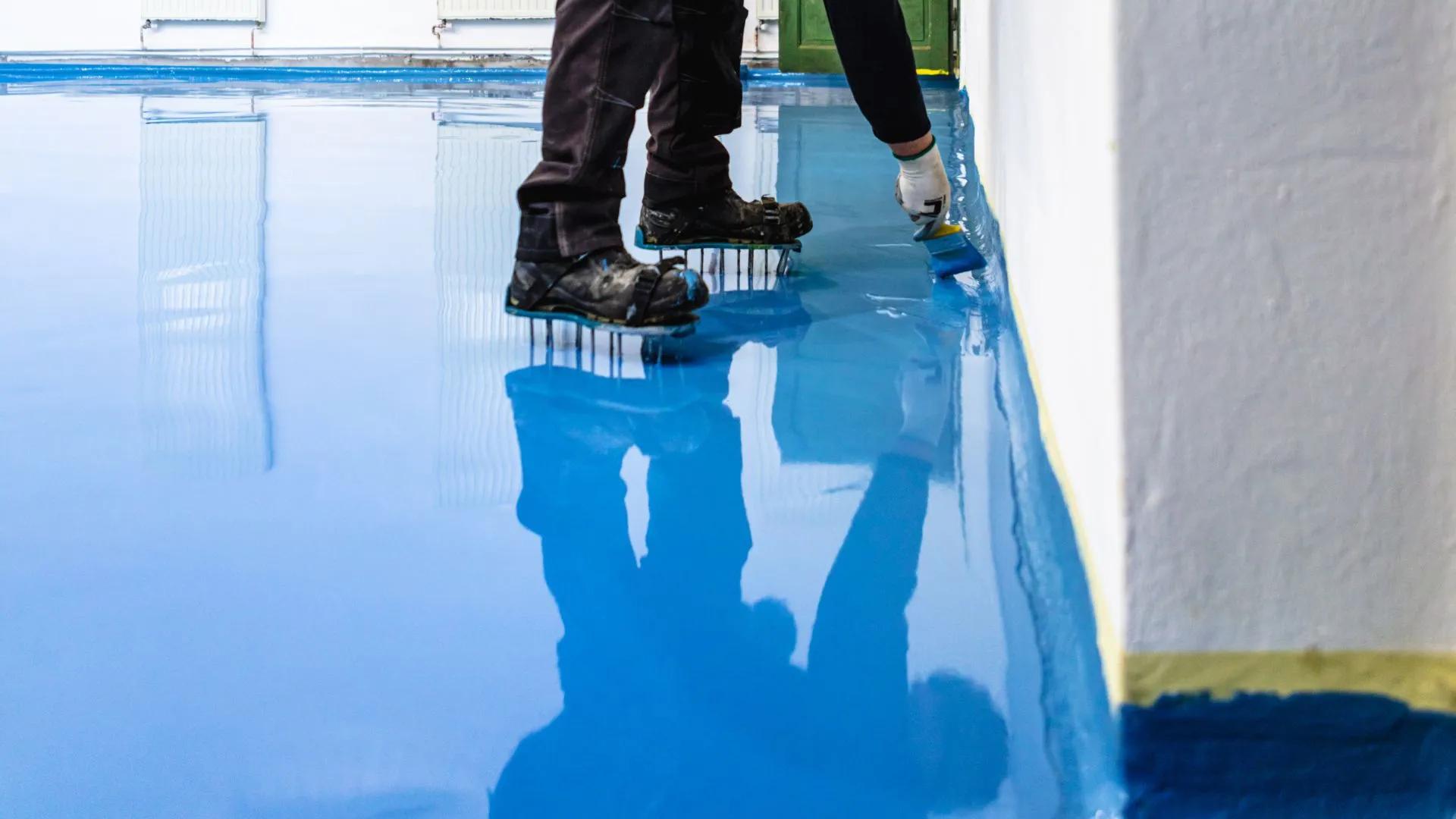 St George's BJ's Painting and Epoxy Floors laying down a fresh residential decorative epoxy floor.